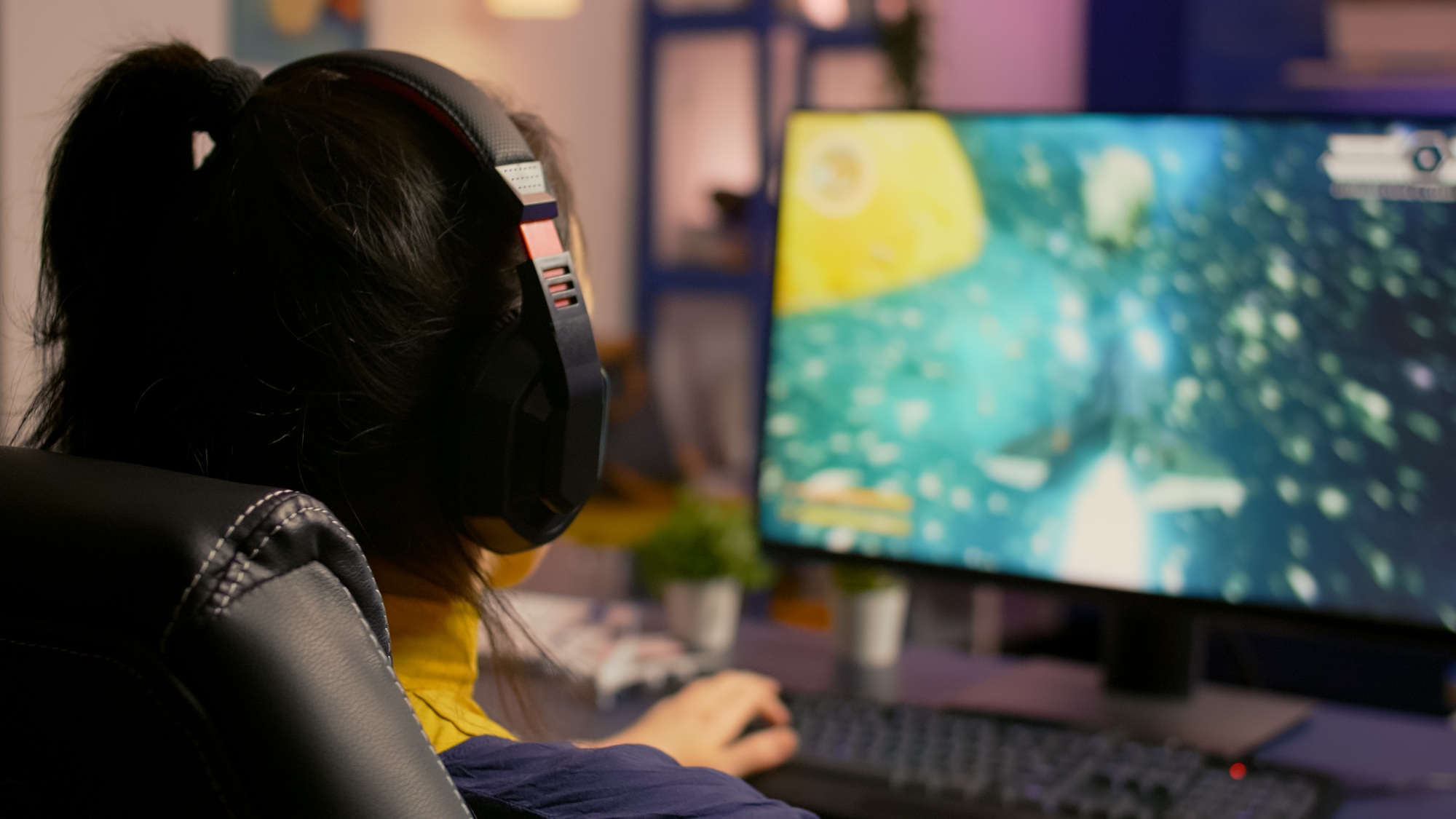 Close-up of gamer sitting on gaming chair